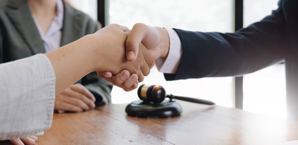 Cacciatore Legal: Federal Employment Lawyer Services & Fee Structure businessman shaking hands to seal a deal with his partner lawyer